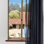 As shown, one-way tracks allow a single-sided window to open without blowing drapes about.